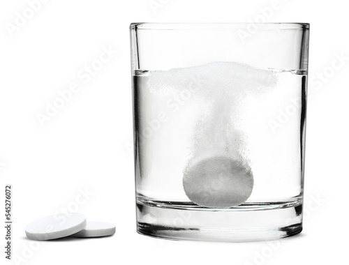 Glass with water and white medical pill