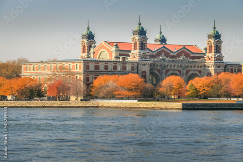 Ellis Island skyline from hudson river at golden autumn in New York , USA