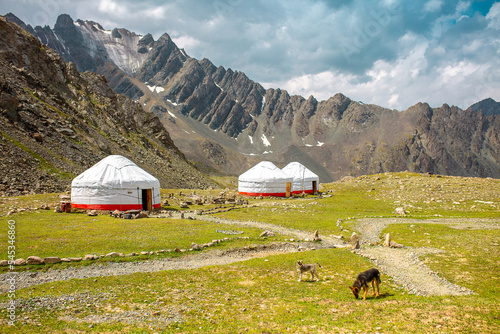 Yurt. National old house of the peoples of Kyrgyzstan and Asian countries. national housing. Yurts on the background of green meadows and highlands. Yurt camp for tourists.