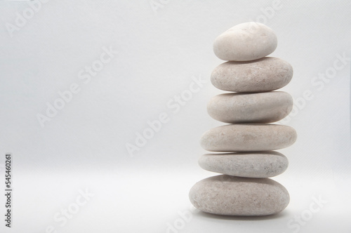 Zen stones stacking on white background with customizable space for text or ideas. Copy space.
