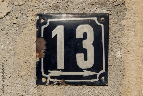 Weathered grunge square metal enameled plate of number of street address with number 13