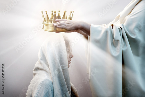 Hands placing a crown on a woman's head