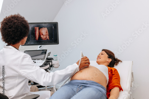 Doctor showing patient baby on ultrasound.