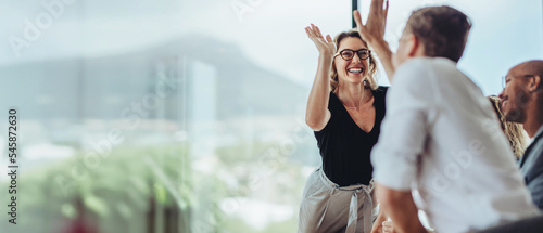 Businesswoman giving a high five to a colleague in meeting