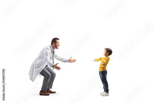 Full length profile shot of a male doctor spreading arms to hug a boy