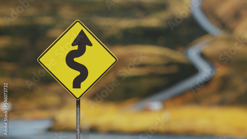 Road sign showing winding bumpy road ahead