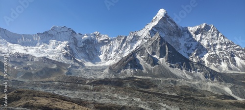 Beautiful high snow capped mountain peaks under blue sky in Mount Everest