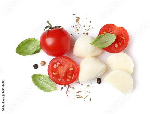 Delicious mozzarella with tomatoes and basil leaves on white background, top view