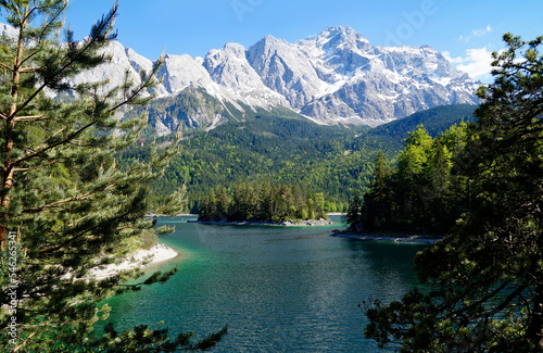 hiking trail overlooking picturesque turquois alpine lake Eibsee (yew lake) by the foot of mountain Zugspitze in Bavaria (the German Alps, Garmisch-Partenkirchen, Grainau, Bavaria, Germany)