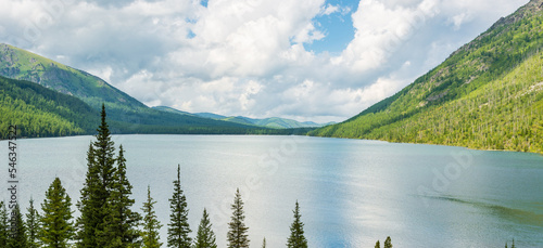 Mountain landscape with beautiful view of the lake and coniferous tree tops