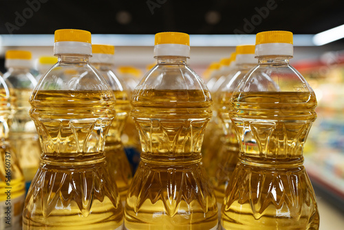 Yellow oil bottles (Soybean oil, Sunflower oil) selling on shelf at supermarket.