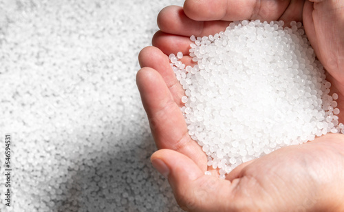 engineer hold white plastic on hand polymer petrochemical product as polymer raw material for plastic in polymer chemical industry design and test in polymer science laboratory