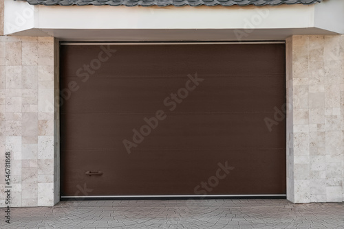 Brown modern counterweight garage doors on building