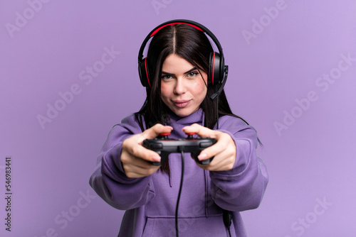 young gamer woman with a headset and a contoller
