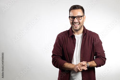 Portrait of young happy IT worker, taken in studio on white background, showing various emotions such as happy, worried, thinking.