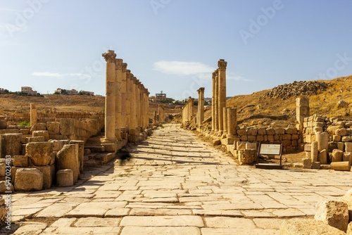 Colonnaded Street with ancient pillars and stones of the Jerash ruins on a sunny day in Jordan