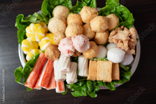 Various steamboat ready to cook ingredient that include fish ball, tofu, squid ball, fish cakes and vegetables.