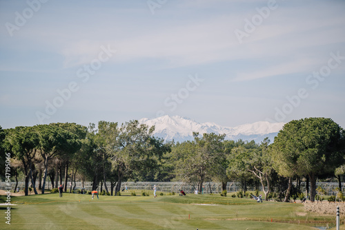 Summer view of green and teeing ground fairway and mountains