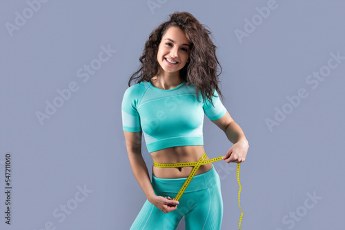 fitness sportswoman dieting at studio. fitness sportswoman dieting isolated on grey