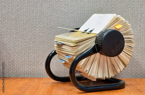 Rolodex file organizer cards sitting open office desk retro gray cubicle partition.