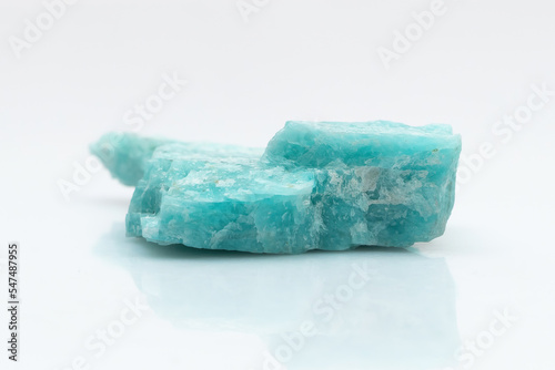 Natural amazonite gemstone isolated on white background. A bluish-green crystal on a white background. A variety of potassium feldspar microcline