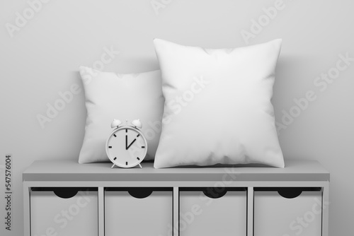 Mockup template with two white blank pillows and clock standing on cabinet with drawers