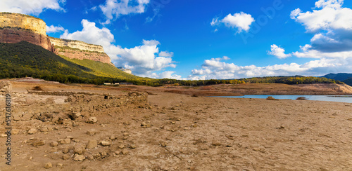 Panoramic view of the Sau reservoir and the Tavertet cliffs during the autumn drought of 2022, with the reservoir at 18%. Catalonia, Spain