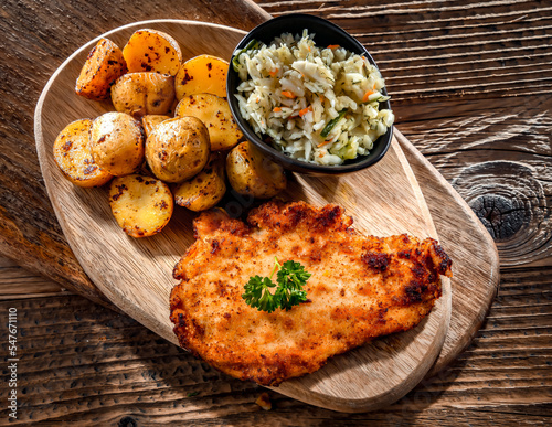 Chicken cutlet coated with breadcrumbs with potatoes and cabbage