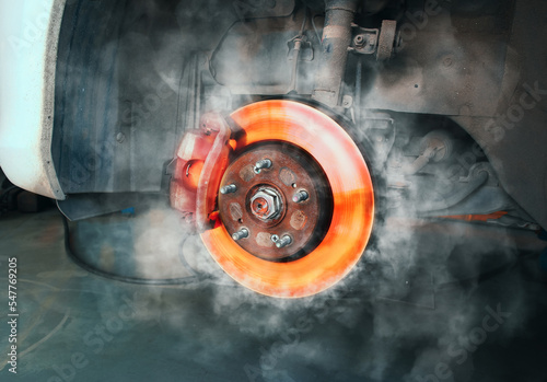 Car brake discs rub against the brake pads until high heat and smoke, automotive maintenance service concept