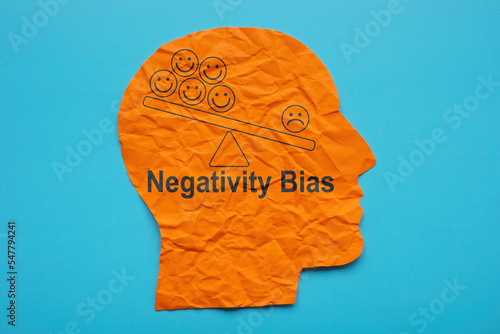 Head from paper and inscription Negativity bias.