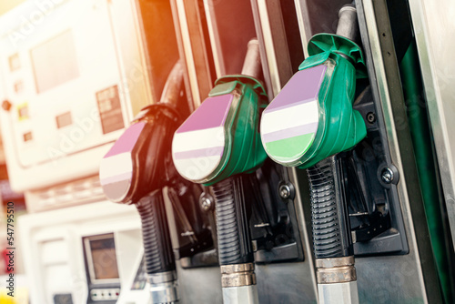 Colorful petrol and diesel nozzles of the dispenser machine at the gas fuel station