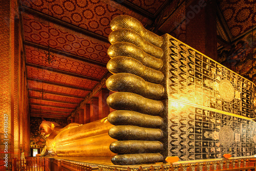 golden reclining buddha statue at wat pho in Bangkok Thailand