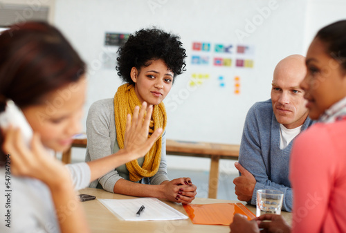 Office, communication and phone call with stop hand for distraction, silence and focus. Shut up, quiet and rude girl employee on smartphone talking at desk with unhappy coworkers together.