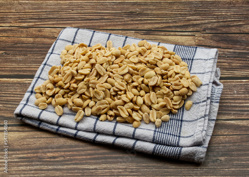 Pealed Peanuts in a bowl isolated on wooden background