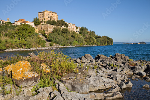 Capodimonte, Viterbo, Lazio, Italy: landscape of the Lake Bolsena and the ancient village with the fortress Rocca Farnese