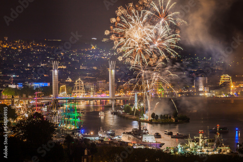 ROUEN, NORMANDY, FRANCE: city lights, Armada 2019 tall ships at night, Flaubert Bridge illuminated and fireworks over the Seine valley
