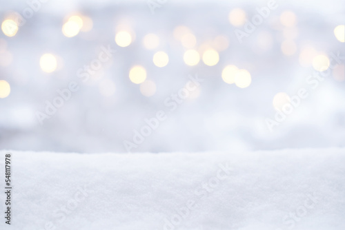 Blurred Christmas lights and snow. Winter background, glitter defocused lights, bokeh, Snowflakes and snowfall