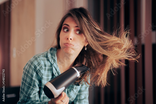 Woman Drying her Hair Using Heat Worried about Healthy Hair. Stressed girl worrying about hair dryer damage 