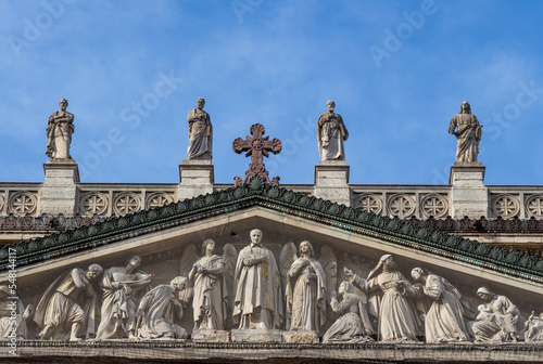 Tympanum and the statues of the church of Saint Vincent de Paul on a sunny day (blue sky), Paris, France.