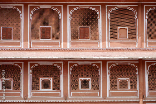 Multiple rooms in city palace, Jaipur, India. Exterior view of palace rooms in pattern with closed windows. Symmetry rooms.