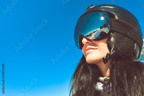 Close up skiers female person goggles with mountains panorama reflection. Ski holiday in caucasus mountains