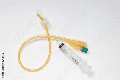 Urinary catheter with syringe 10 ml on a white background, test