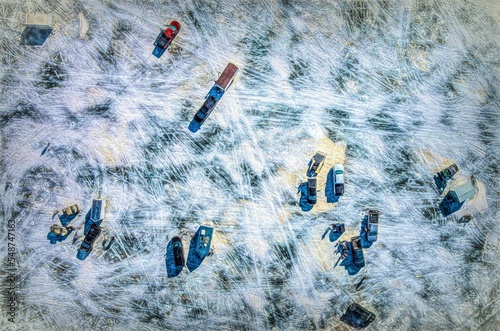Aerial view of cars and moveable huts placed on a frozen lake