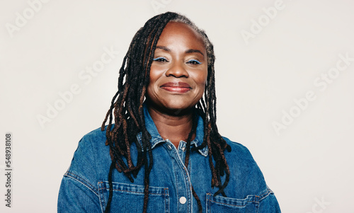 Portrait of a mature woman with dreadlocks looking at the camera with a smile