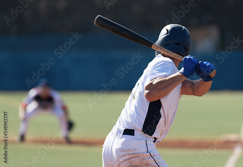 Baseball players in action on the stadium, baseball batter waiting to strike the ball