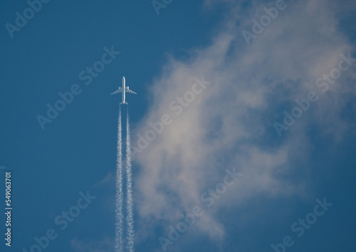 The airliner flies at high altitude, among the clouds. Vacations, trips - concept.