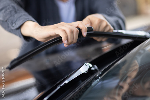 Technician replacing windshield wipers change car wiper blades