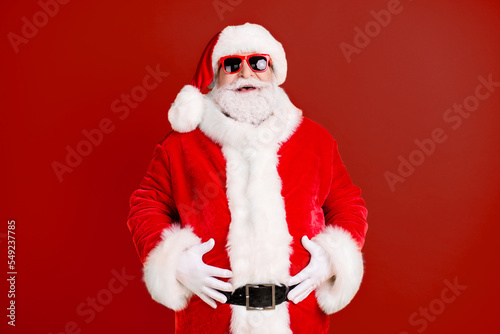 Portrait of his he nice funny glad cheerful cheery white-haired Santa big belly stomach abdomen laughing ho-ho having fun isolated bright vivid shine vibrant yellow color background