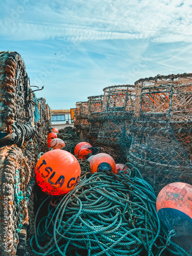 Lobster pots and crab pots with ropes and floats on the quayside at Mudeford, Christchurch in Dorset, UK