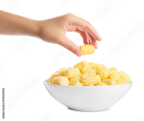 Woman taking corn puff from bowl on white background